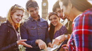 Image of a diverse group collaborating with a map near Big Ben, promoting "team building" through social interaction and planning.